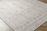 Close-up of the Xipil Area Rug. Traditional vintage style with dark red, ivory, and pale blue floral pattern. Corner