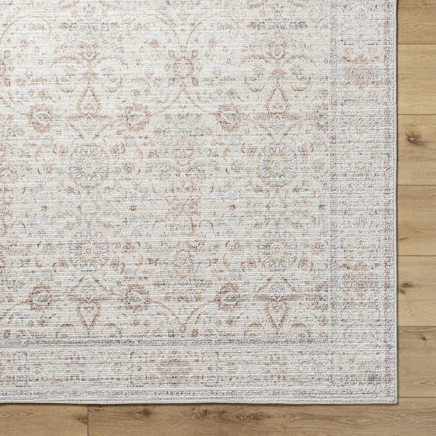 Close-up of the Xipil Area Rug. Traditional vintage design in dark red, ivory, olive, and pale blue. Corner