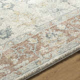 Close-up of the Yetta Beige Thick Luxe Area Rug showing its beige, pink, and gray farmhouse pattern and plush texture. Texture