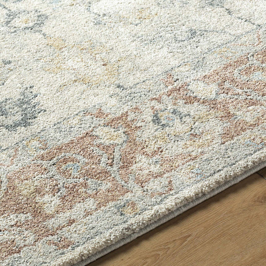 Close-up of the Yetta Beige Thick Luxe Area Rug showing its beige, pink, and gray farmhouse pattern and plush texture. Texture