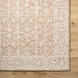 Close-up of the Yadid Brown Wool Area Rug showing its tan and pearl farmhouse pattern and hand-tufted texture. Swatch