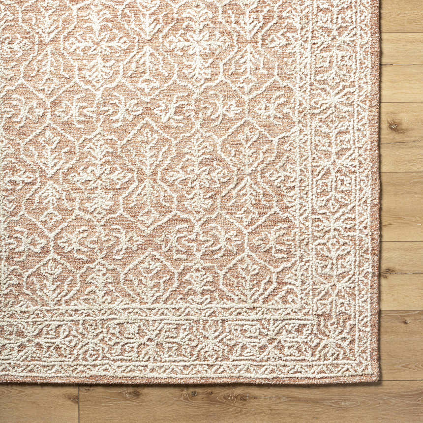 Close-up of the Yadid Brown Wool Area Rug showing its tan and pearl farmhouse pattern and hand-tufted texture. Swatch