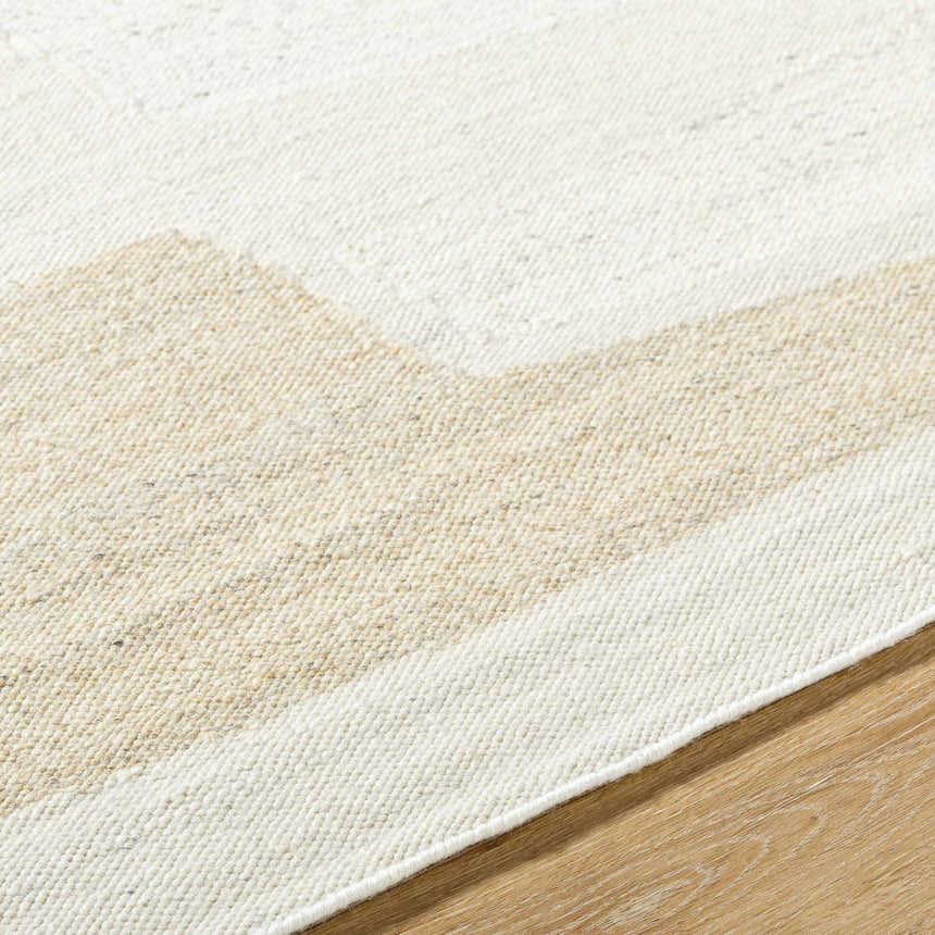 Close-up of the hand-woven Airell Area Rug. The rug features a geometric pattern in pearl and brick red wool. Contemporary style. Texture