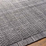 Close-up of the Hand Loomed Light Gray Area Rug, showing texture and pattern detail. Recycled PET yarn rug. Texture