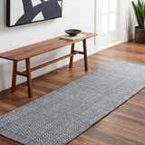 Entryway with Hand Loomed Light Gray Area Rug, wood bench, and modern art. Roomscene-Runner