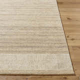 Close-up of the hand-tufted Yosef Area Rug. Prairie dust, tan, and warm gray tones with a subtle horizontal stripe pattern. Front