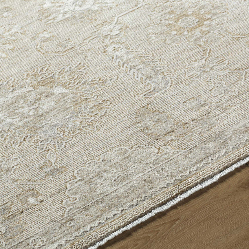 Close-up of the Yonca Luxe Rug in ash and light silver, showing the traditional floral pattern and soft polyester texture. Texture
