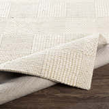Close-up of the hand woven Yarrabilba Area Rug, showing the ivory wool texture and construction. Fold