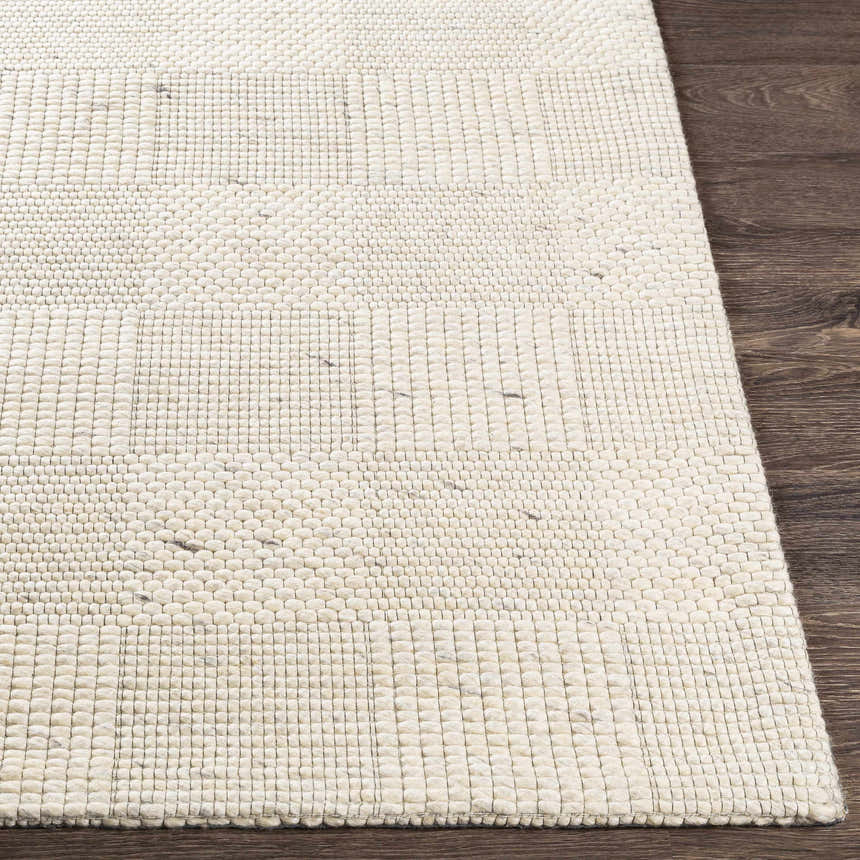 Close-up of the hand woven Yarrabilba Area Rug showing ivory color, texture, and contemporary design. Front