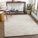 Living room scene with ivory Yarrabilba area rug, wood floors, chair, and console table. Roomscene-Rectangle
