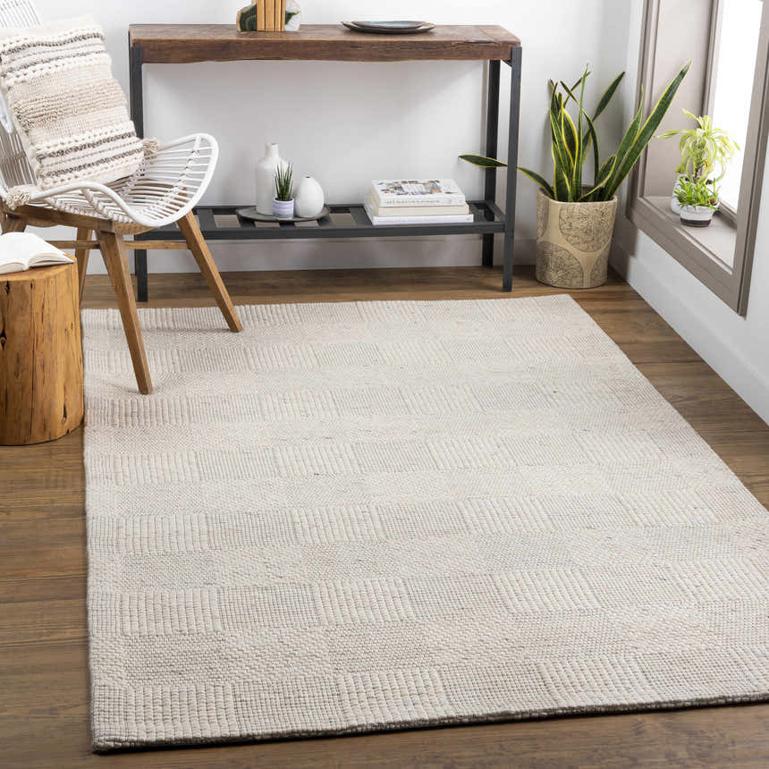 Living room scene with ivory Yarrabilba area rug, wood floors, chair, and console table. Roomscene-Rectangle