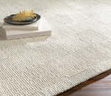 Close-up of the hand woven Yarrabilba Area Rug showing off white wool texture and subtle black and charcoal details. Styleshot