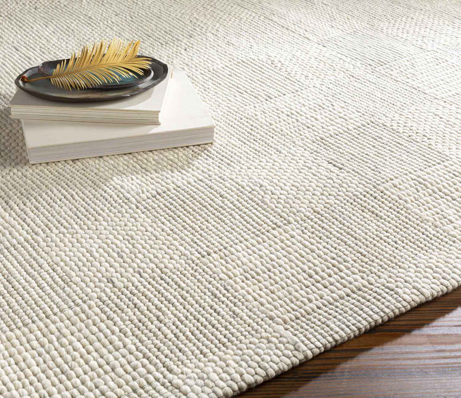 Close-up of the hand woven Yarrabilba Area Rug showing off white wool texture and subtle black and charcoal details. Styleshot