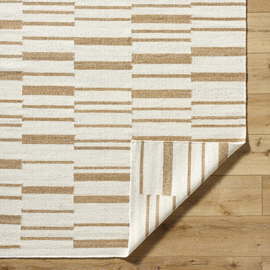 Close-up of Zofia area rug showing camel and pearl stripes, hand-woven wool texture, and flipped corner. Fold
