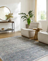 Living room scene with neutral armchairs and the Zilya Area Rug in dark brown, green, peach, and rust tones. Roomscene-Rectangle