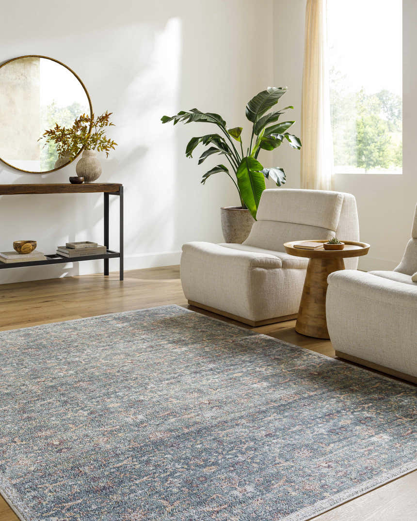 Living room scene with neutral armchairs and the Zilya Area Rug in dark brown, green, peach, and rust tones. Roomscene-Rectangle