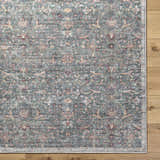 Close-up of the Zilya Area Rug showcasing its traditional floral pattern in dark brown, green, peach, and rust tones. Corner