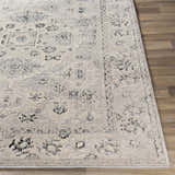 Close-up of the Zephyr Area Rug. Traditional farmhouse design in black, charcoal, light slate, peach, and taupe. Front