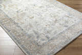 Close-up of the Uriel Thick Luxe Rug. Beige, gray, and tan traditional pattern on a machine woven rug. Corner