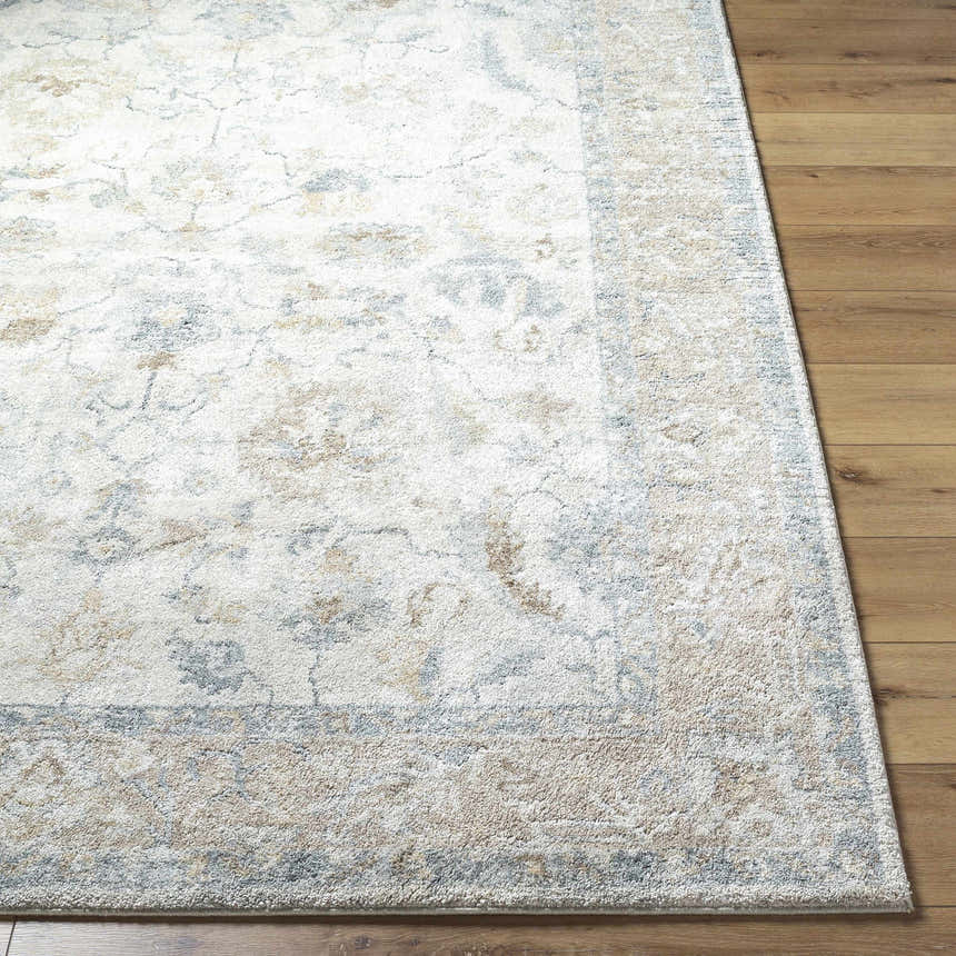 Close-up of the Uriel Thick Luxe Rug showing beige, gray, and tan traditional pattern and plush texture on wood floor. Front