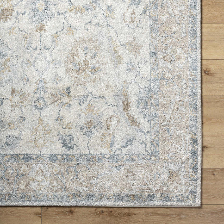 Close up of the Uriel Thick Luxe Rug showing beige, gray, and tan traditional pattern and soft texture. Corner