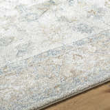 Close-up of the Uriel Thick Luxe Rug. Beige, gray, tan, and teal hues create a soft, textured farmhouse design. Texture