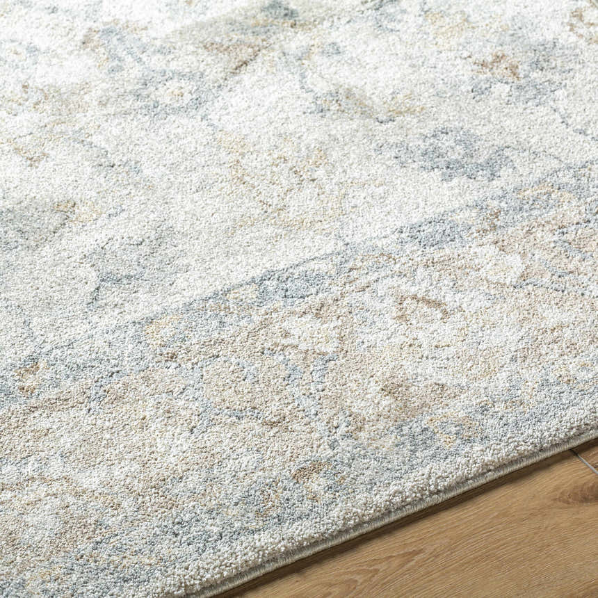 Close-up of the Uriel Thick Luxe Rug. Beige, gray, tan, and teal hues create a soft, textured farmhouse design. Texture