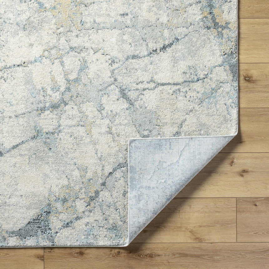 Close-up of the Urowo Light Gray Thick Luxe Rug showing its cream, gray, and light blue contemporary design and texture. Fold